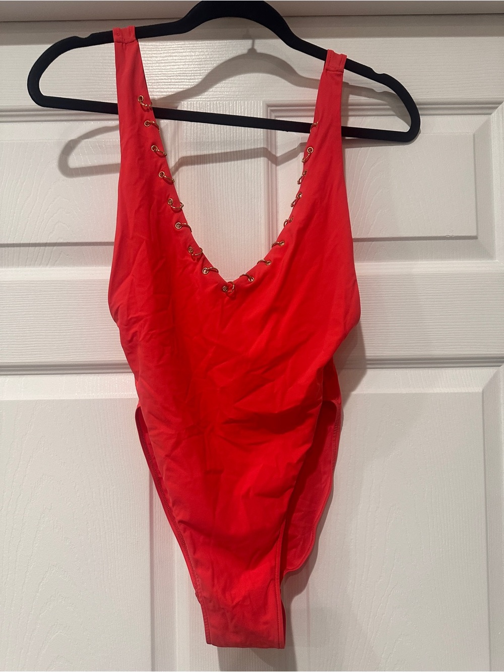 Bold Hot Pink One-Piece Swimsuit with Grommet Detail